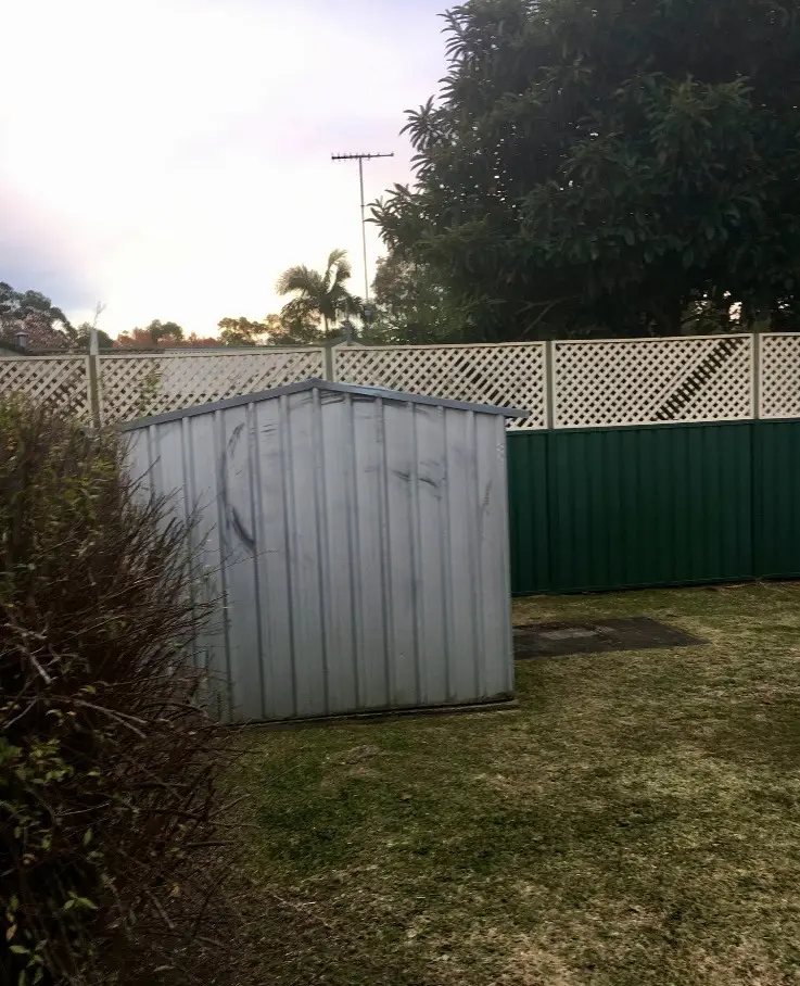 The original garden — a tired shed, plain lawn and weathered fencing